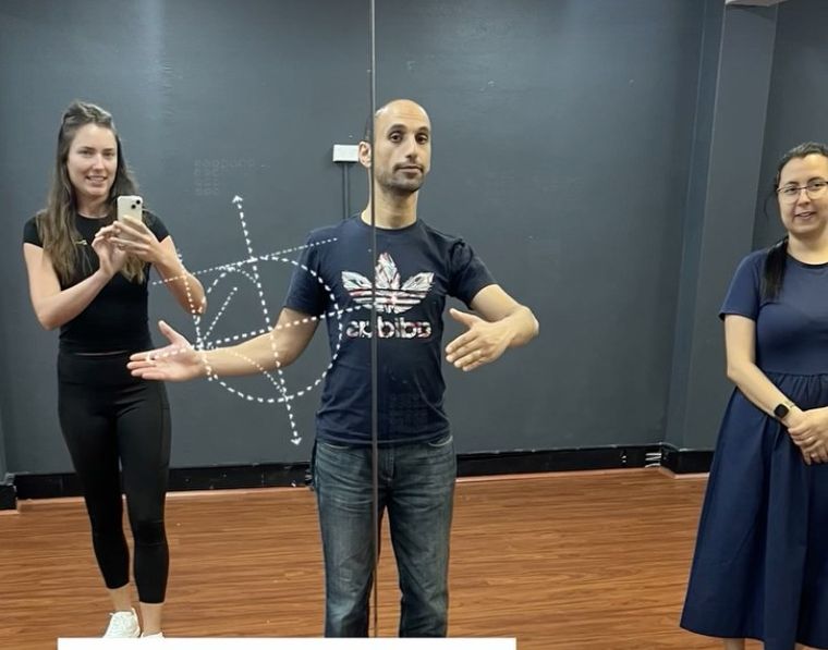 Aleksandra teaching a couple the partner dance frame