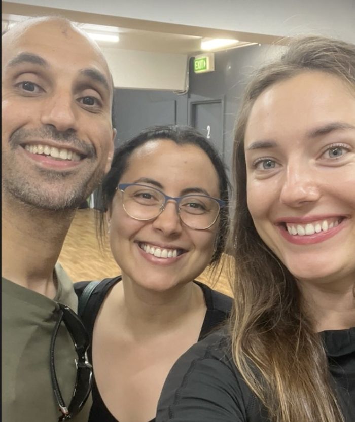 A couple smiling with Aleksandra after a first-dance lesson