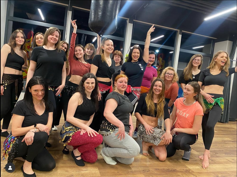 Aleksandra's students posing together after class, all smiles